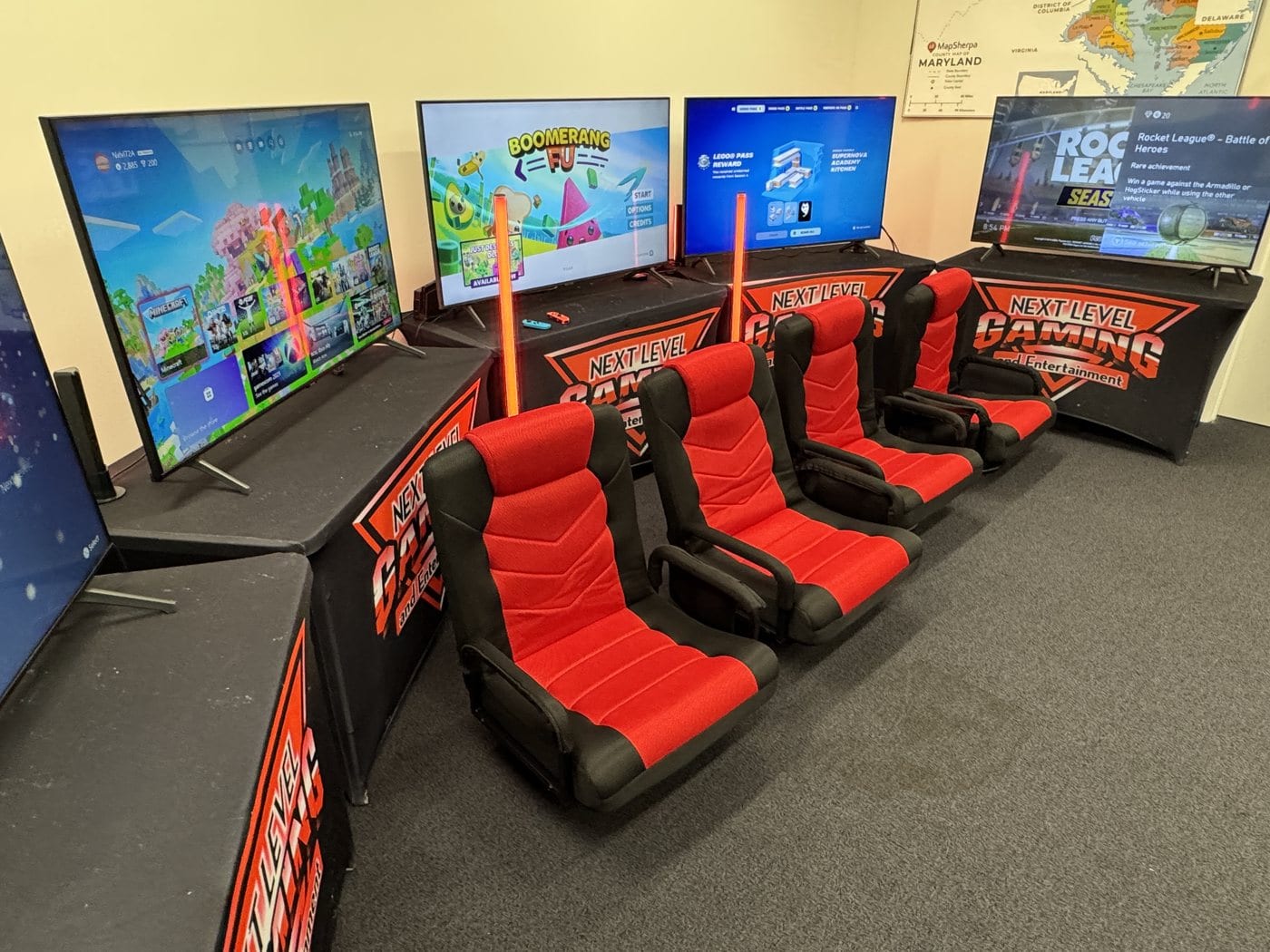 A Next Level Gaming mobile arena lounge with red gamer chairs in the DMV
