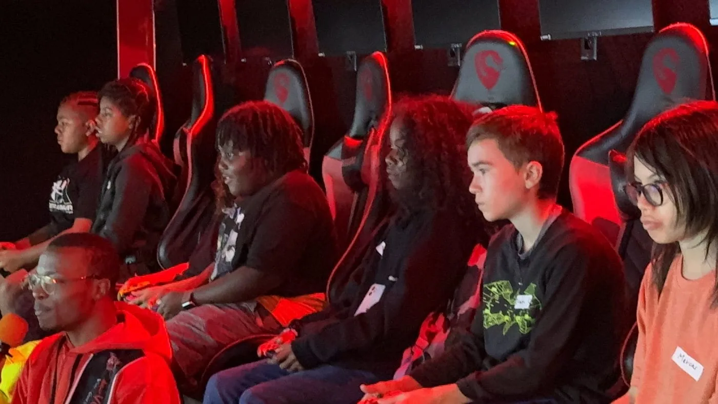 A full crew playing together inside the Next Level Gaming theater